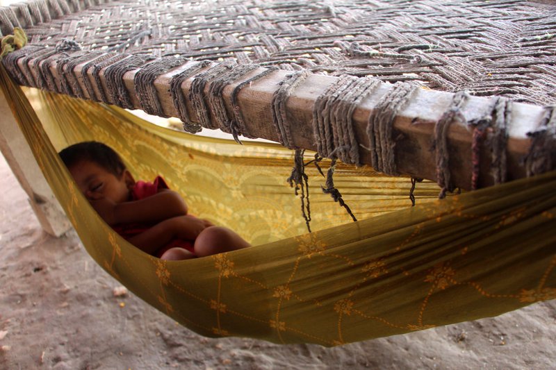 Barn á flótta hvílir sig í hengirúmi í búðum sem komið hefur verið upp í norðurhluta landsins. Mynd: EPA